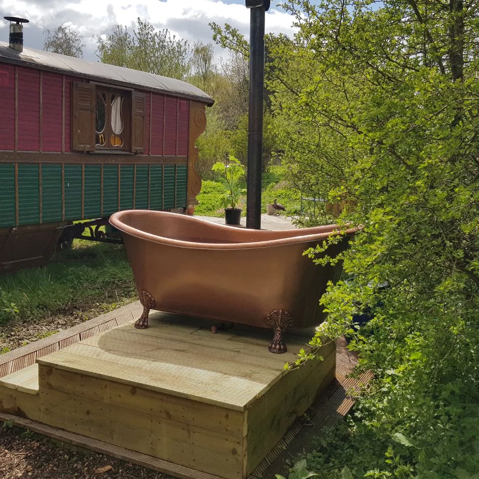 Coppersmith Creations Hammered Clawfoot Copper Double Slipper Tub installed outside