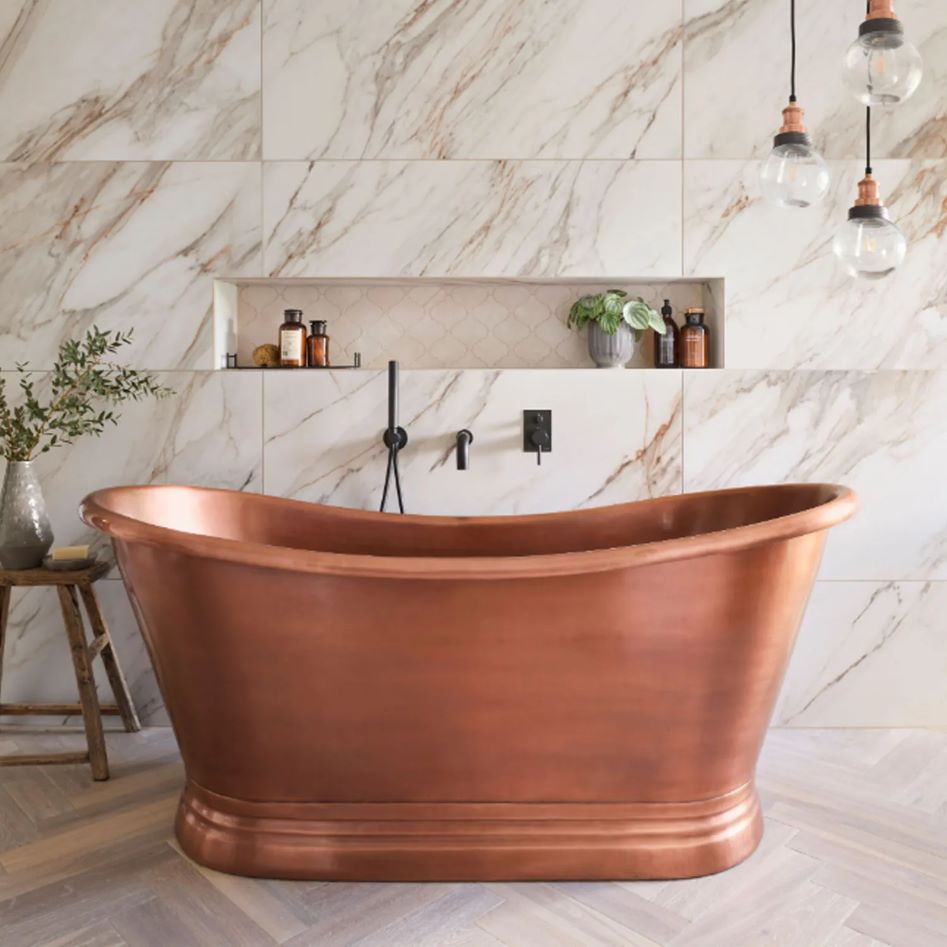Coppersmith Creations Slanted Cascading Base Copper Bathtub Full Antique Finish installed in light tiled room side view